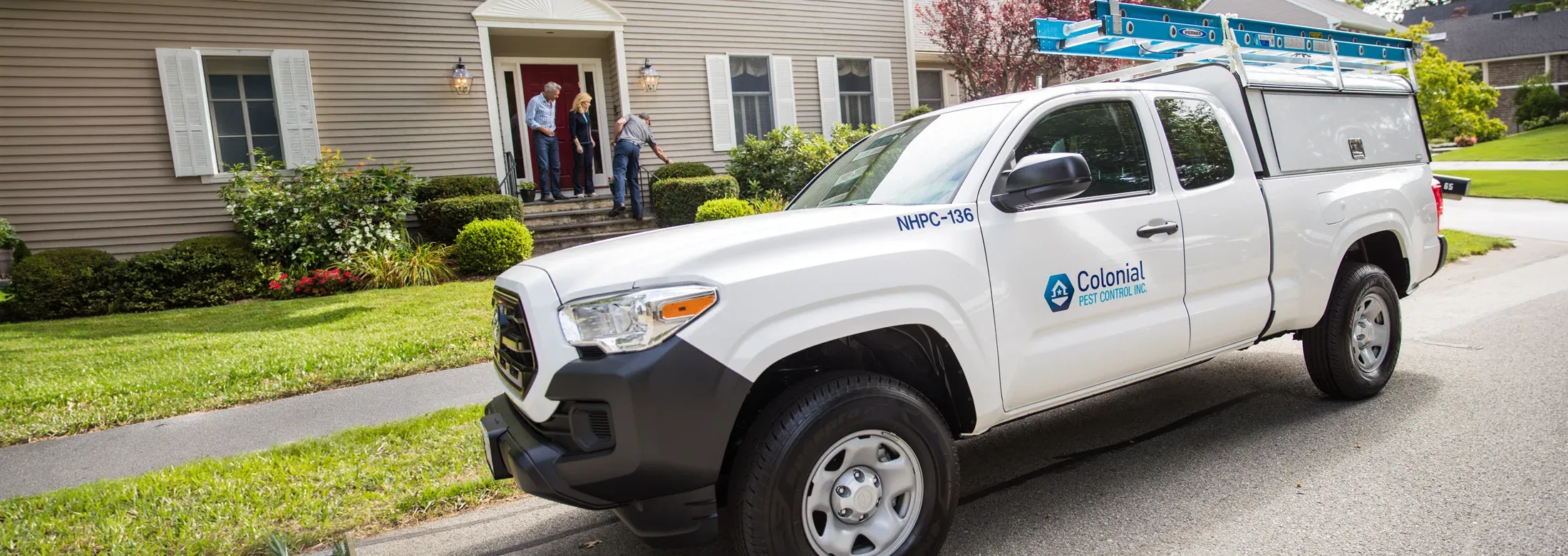 Colonial Pest truck in front of customers house